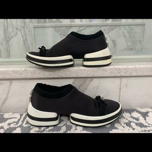 Stuart Weitzman “dressy black sneaker.”sophisticated and Like walking on clouds.